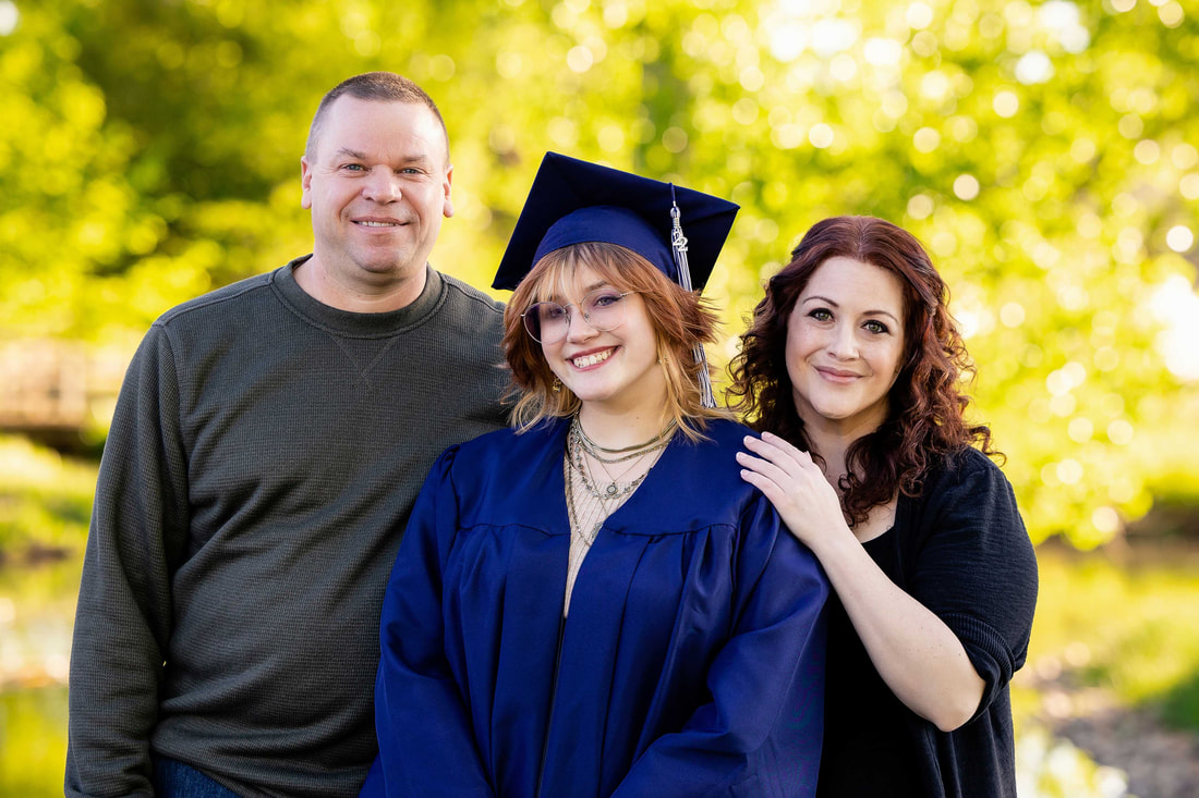 littleton high school senior photographers-cap and gown with family